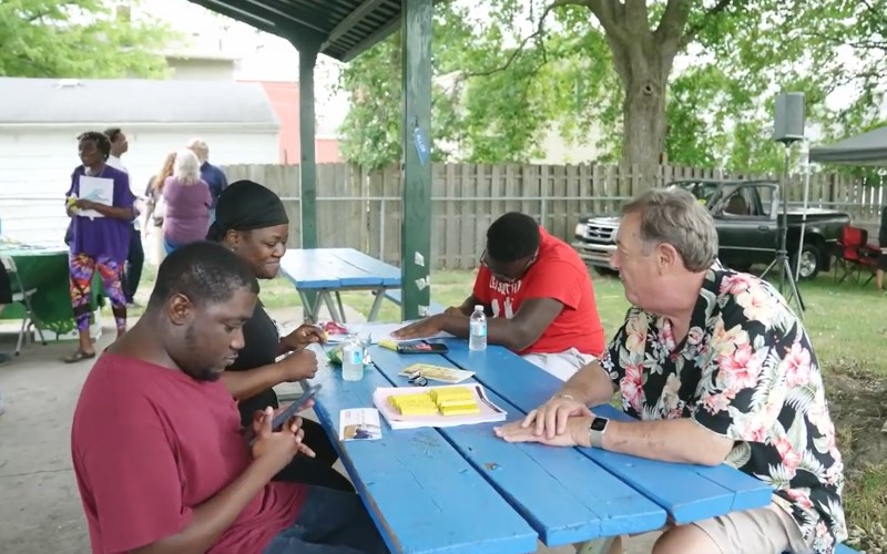 Gordon Gauss talking with neighbors at Parish Park in Adrian